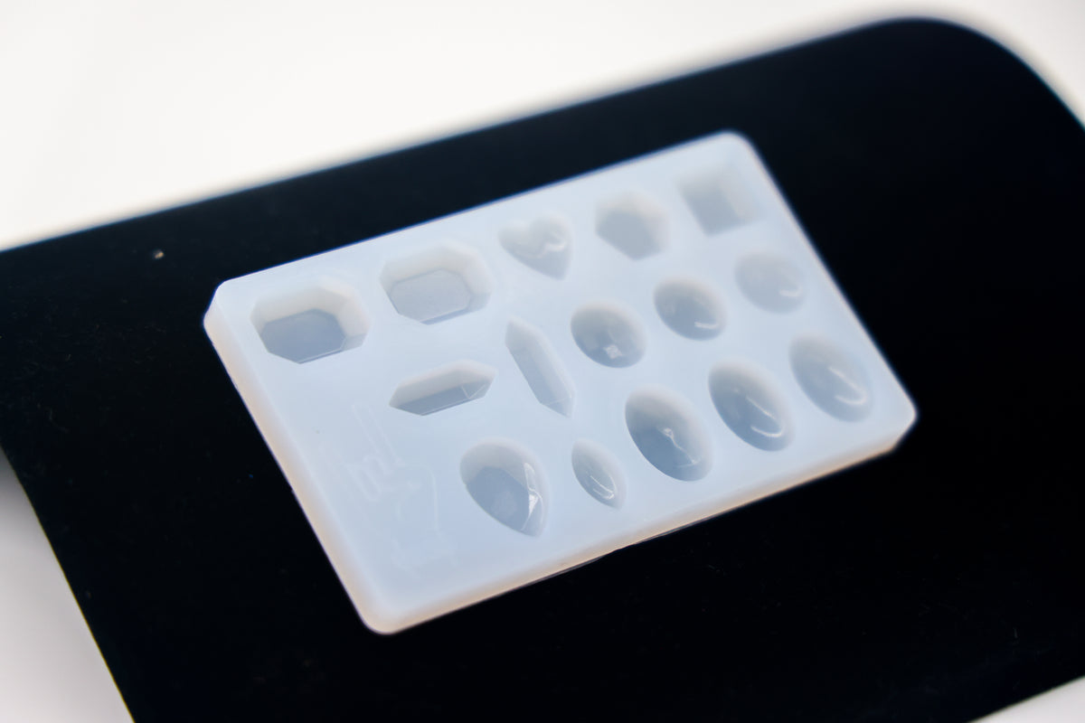 a clear silicone mold used to make faux gemstones with uv resin and epoxy
